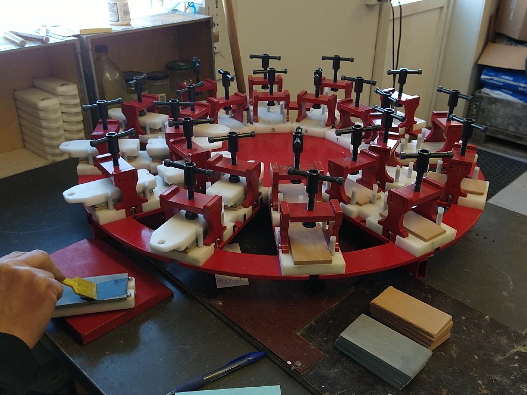 Red circular equipment for gluing whetstones together